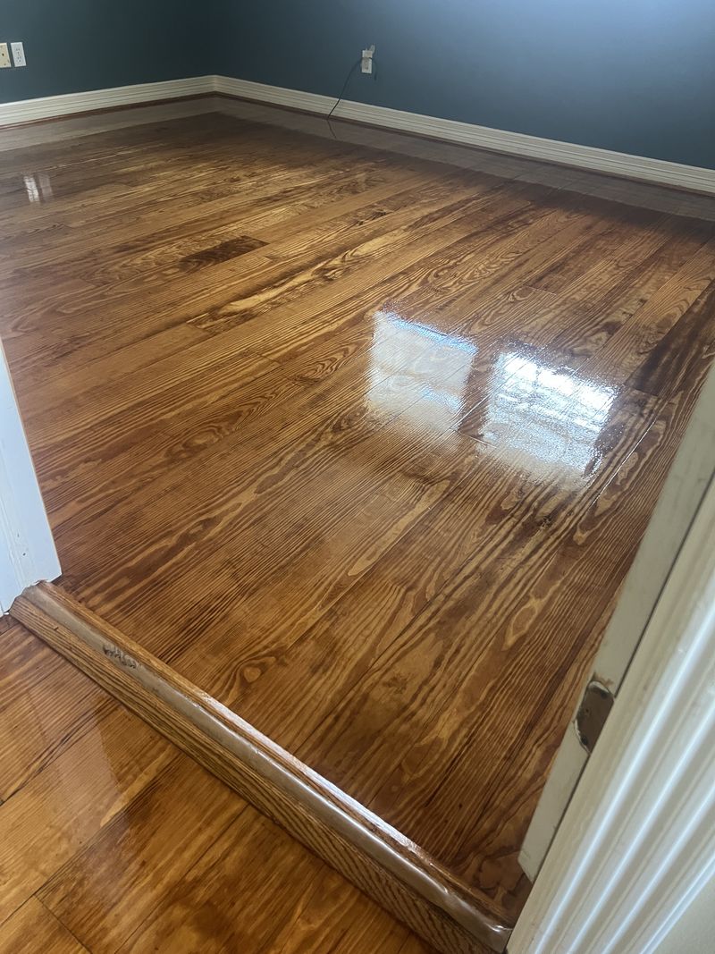 Hardwood floor with a dark walnut stain and high gloss